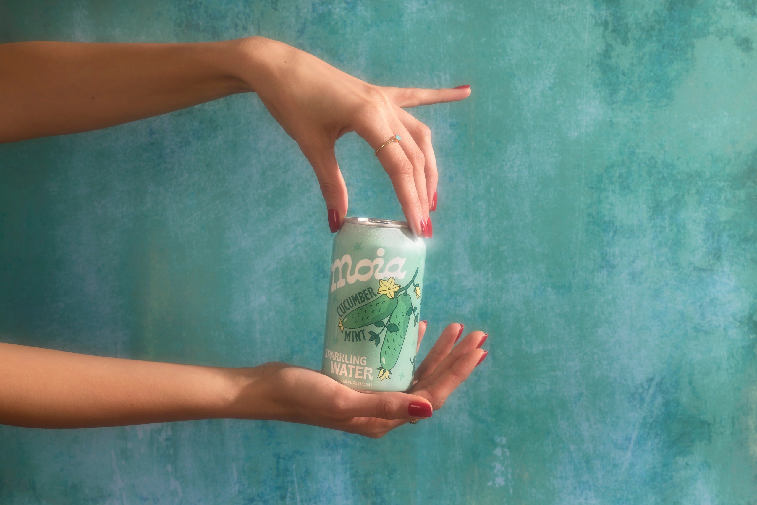 Hand touching a moia can